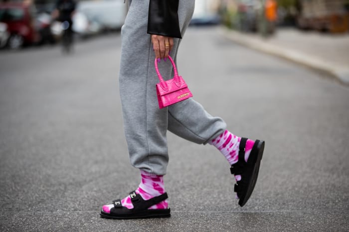 woman-wearing-grey-sweatpants-with-tie-dye-socks-chanel-sandals-pink-mini-jacquemus-bag.jpg