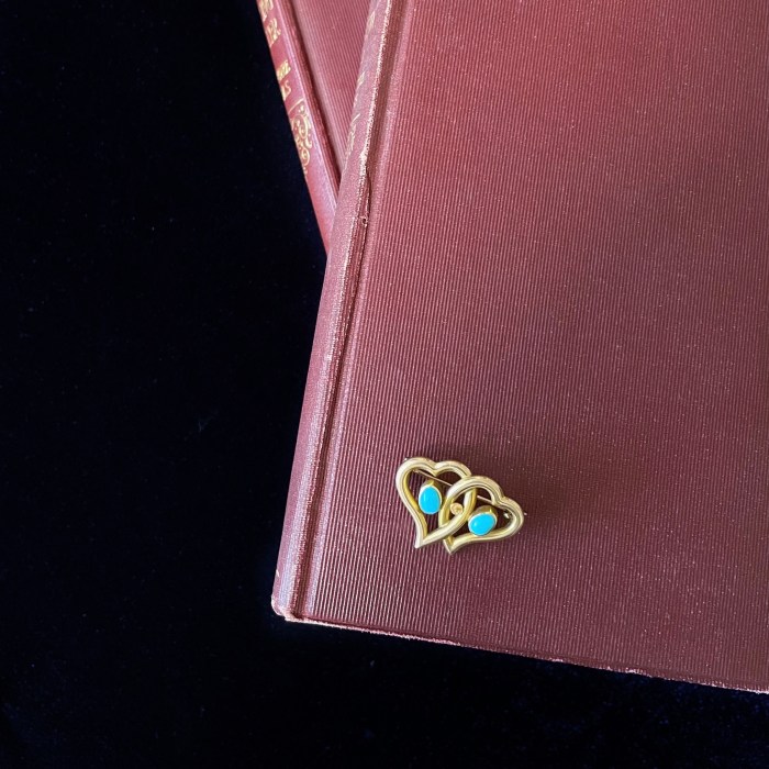 A late 19th century 15K gold turquoise double heart brooch sold in a jewelry auction at Fellows Auctions.