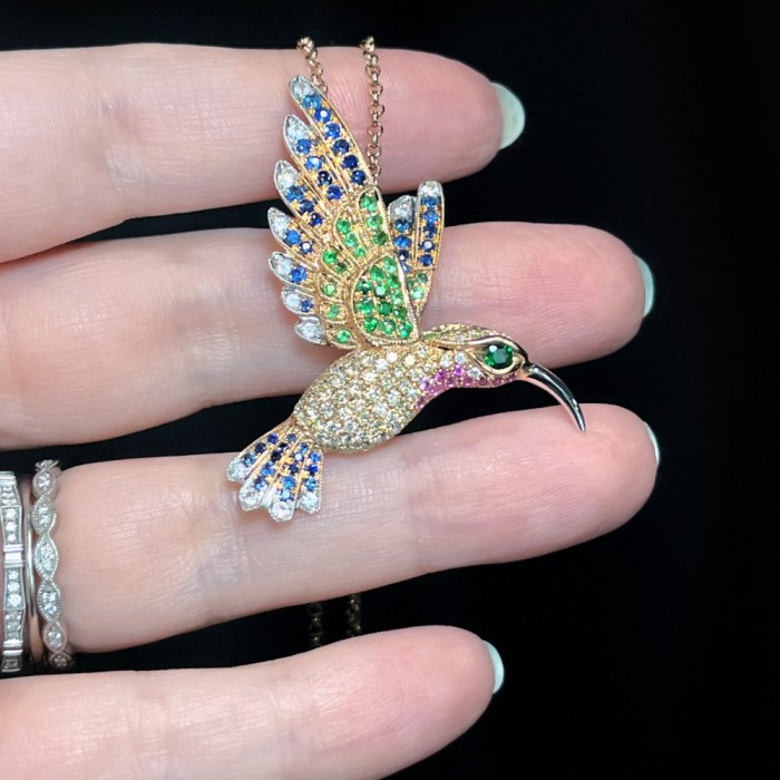 18K rose gold Hummingbird necklace with blue Sapphires, green Garnets, pink Sapphires, and Diamonds. By LeVian. Seen at AGTA's 2022 Spectrum Awards. 