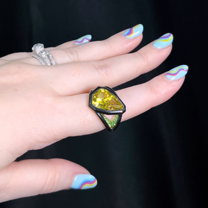 18K yellow gold and black ceramic ring with a 4.03 ct. natural fancy deep yellow Diamond and tsavorite Garnets. By Jeffrey Bilgore. Seen at AGTA's 2022 Spectrum Awards. 