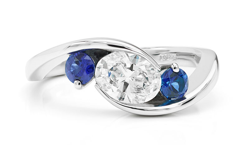 3 stone Trilogy style ring with blue sapphire and diamonds